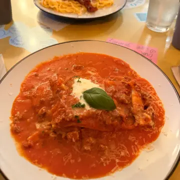 Lasagna in red sauce with mozzarella and basil